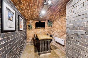The industrial-style meeting room at Bank Chambers, a virtual office in Stockport, Greater Manchester.